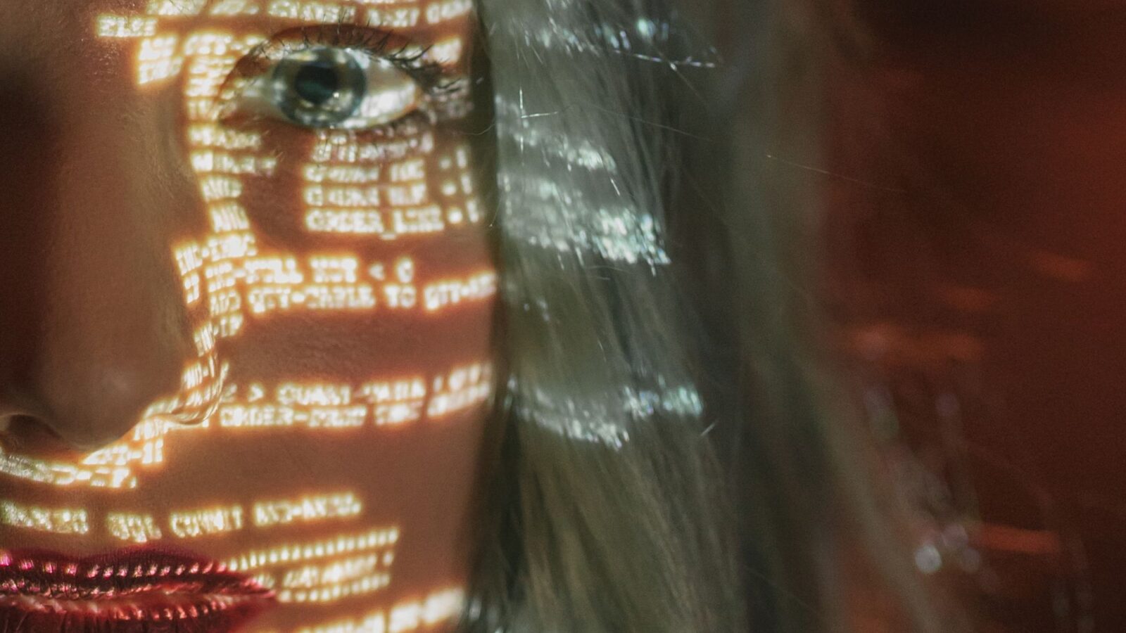 Digital code projected across a face for synthetic media and deepfake research